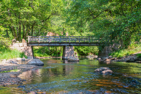 old stone bridge over a small stream on a sunny day