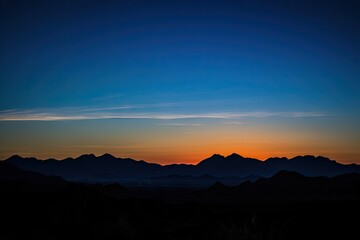 Fototapeta premium sunset, with silhouetted mountains and clear blue sky, created with generative ai
