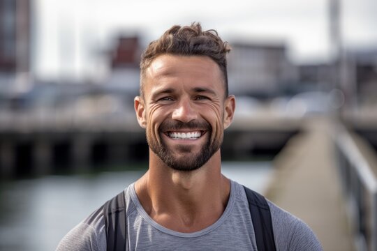 Headshot portrait photography of a grinning boy in his 30s working out against a riverfront background. With generative AI technology