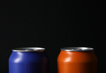 Cans of fresh soda on dark background, closeup