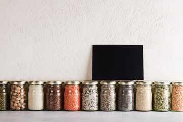 Zero waste lifestyle concept. Responsible consumption, healthy vegetarian food. black board for text on glass with food containing proteins and fats.