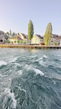 Vertical video of the Reuss river as it passes through the city of Lucerne in Switzerland.