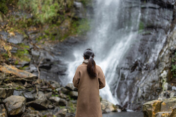 Fototapeta na wymiar Tourist woman go hiking view the Wufengqi waterfall in Yilan of Taiwan