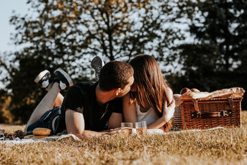 Young couple having a picnic in the park.