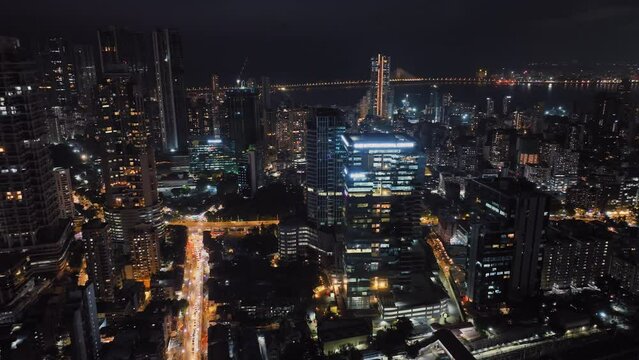Cinematic aerial view of Mumbai's downtown night scene. Central Mumbai's cityscape and skyline- Lalbaug-Parel, Worli, Prabhadevi. beautiful modern buildings, bright glowing lights, and roads.