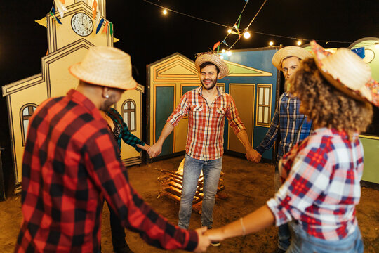 Festa Junina in Brazil. Group of friends dancing the Brazilian square dance.