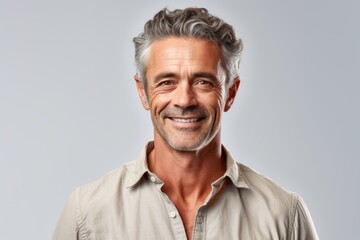 Medium shot portrait photography of a grinning mature man wearing a casual short-sleeve shirt against a white background. With generative AI technology
