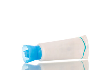 One plastic tube of toothpaste, macro, isolated on white background.