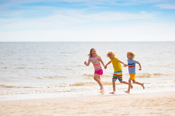 Kids play on tropical beach. Sand and water toy.