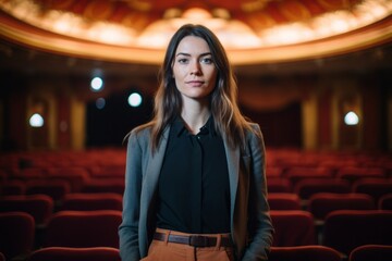 Medium shot portrait photography of a satisfied girl in her 30s wearing a smart pair of trousers against a classic theater background. With generative AI technology