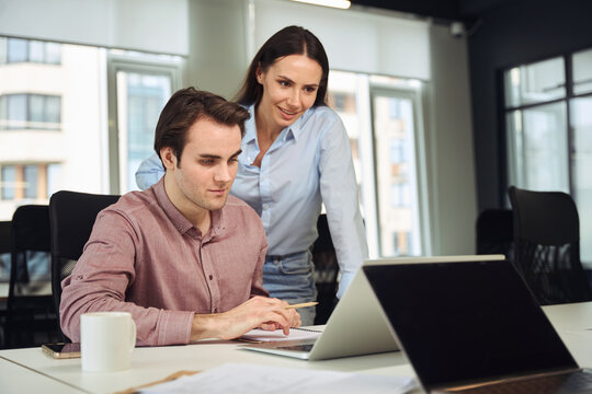 New timid employee demonstrating his task performance to company manager
