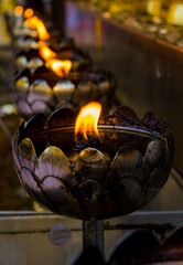 Brass candlestick shaped like lotus on temple attractions in Thailand.