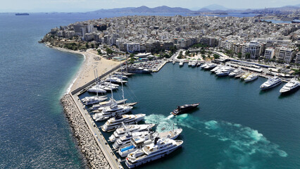 Fototapeta premium Aerial drone photo of beautiful yacht manoeuvring inside round port of Zea or Passalimani a safe anchorage in seaside area of Piraeus, Attica, Greece