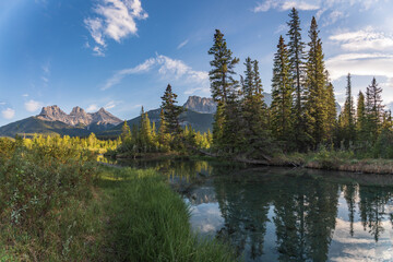 Views near Banff National Park, during summer time with magnificent mountain peaks in view. Creek, stream, wilderness, water, summer time, huge mountains.