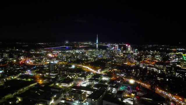 Aerial View of Auckland City Skyline at Night. Ascending upwards over the city. 