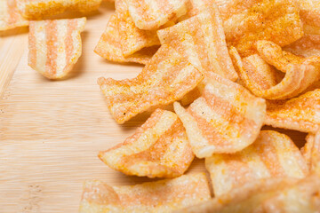 crispy potato chips on a wooden kitchen board