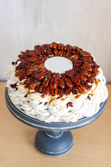 Delicious Pavlova cake with pecans, chocolate sauce, maple syrup and fondant plate for text