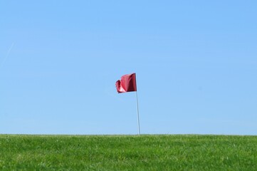 Golf hole waving flag on horizon. Very small golf club Búřov Valašská Bystřice in countryside...