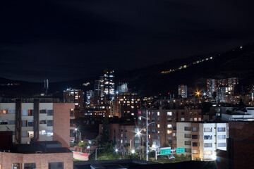 Fototapeta na wymiar Bogota night cityscape with skyscrapers and oriental mountain range at background