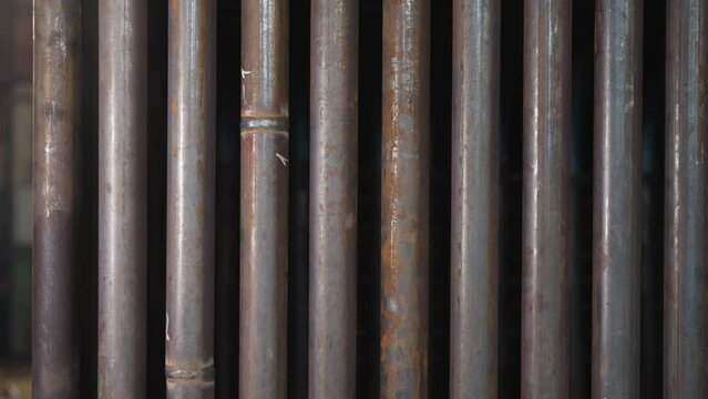 Metal pipes row with welding seams in factory storehouse