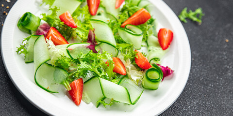 strawberry salad cucumber, lettuce healthy meal food snack on the table copy space food background rustic top view 