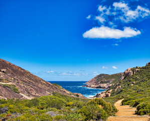 Fototapeta na wymiar The granite coast with turquoise water at Cape Le Grand National Park, Western Australia. In the distance islands of the Recherche Archipelago 