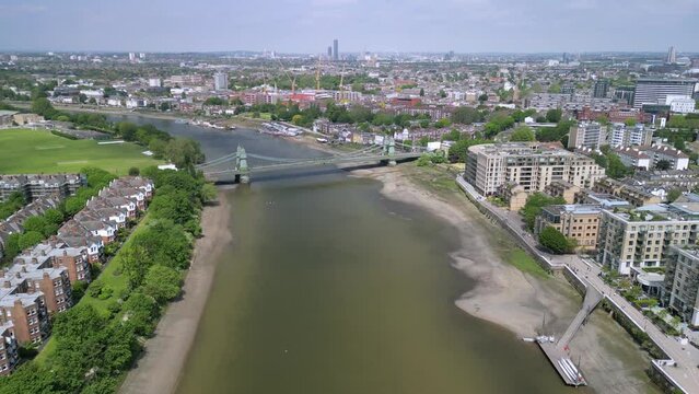 The drone aerial footage of Hammersmith bridge across River Thames in west London, links Hammersmith and Barnes.