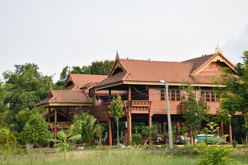 Fototapeta na wymiar Exterior building traditional Thailand style with green garden, wooden house beautiful detail architecture