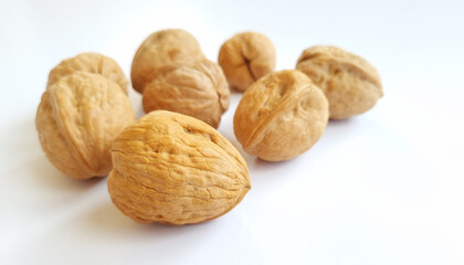 Walnuts on a bright white background with natural lighting. Healthy food, and one of the symbols for the Passover holiday and also for the Tu Bishvat holiday. close up 