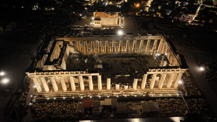 Aerial drone night shot of iconic illuminated Acropolis hill and the Parthenon an Unesco world...
