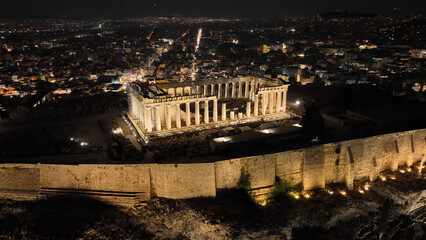 Aerial drone night shot of iconic illuminated Acropolis hill and the Parthenon an Unesco world heritage site and one of the most important monuments of Western civilisation, Athens, Attica, Greece