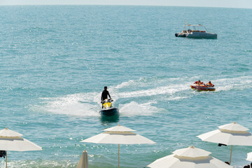 Abkhazia Gagra 08.06.2023 Entertainment at sea, riding on an inflatable boat tied to a jet ski