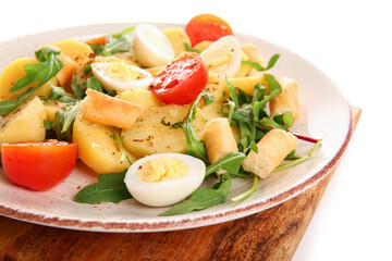 Plate of tasty potato salad isolated on white, closeup