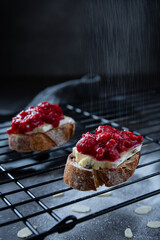 Sandwiches with cheese and raspberry jam on dark background `