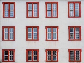 Weathered Red-Arched Vintage Windows on an Old Classical House