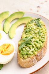 Plate of tasty bruschetta with avocado on table, closeup