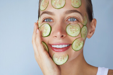 Skin detox. Cucumber facial mask. Beauty portrait of young woman make daily skincare routine....