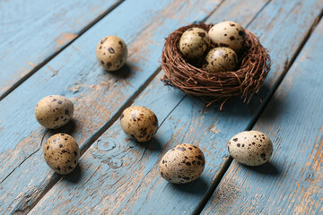 Fresh quail eggs on blue wooden background