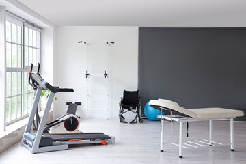 Interior of rehabilitation center with couch and equipment