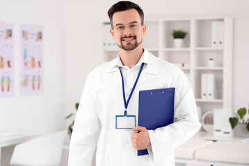 Male physiotherapist with clipboard in rehabilitation center