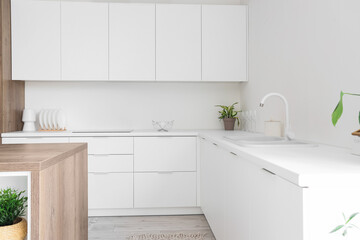 Interior of light kitchen with white counters