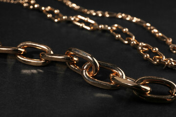 Fototapeta premium Beautiful chain bracelets on black background