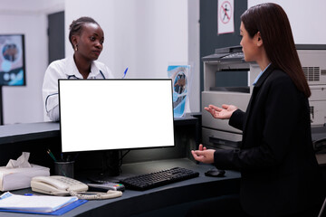 Reception worker manages patient records and schedules appointments typing medical information on computer with white isolated screen. Hospital staff working at health care treatment for patients