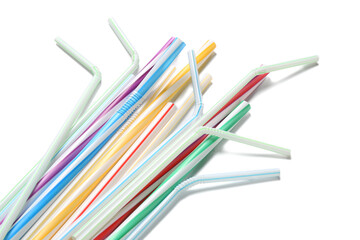 Different plastic drinking straws on white background