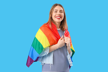 Young woman with LGBT flag on blue background