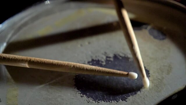 Unrecognizable musician man drummer is playing hitting drum on drums kit.