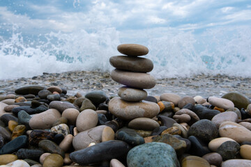 Fototapeta na wymiar Beautifully laid stones against the background of the sea surf