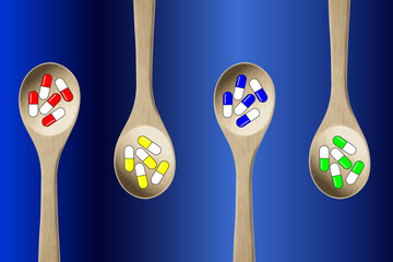 Colorful pills-capsules of medicines, vitamins or supplements in wooden kitchen spoons on blue background. Concept of medicine and health	