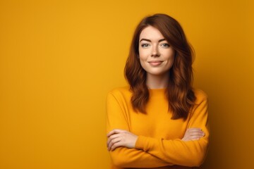 Fototapeta premium Headshot portrait photography of a satisfied girl in her 20s crossing the arms against a mustard yellow background. With generative AI technology