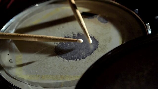 Unrecognizable musician man drummer is playing hitting drum on drums kit.